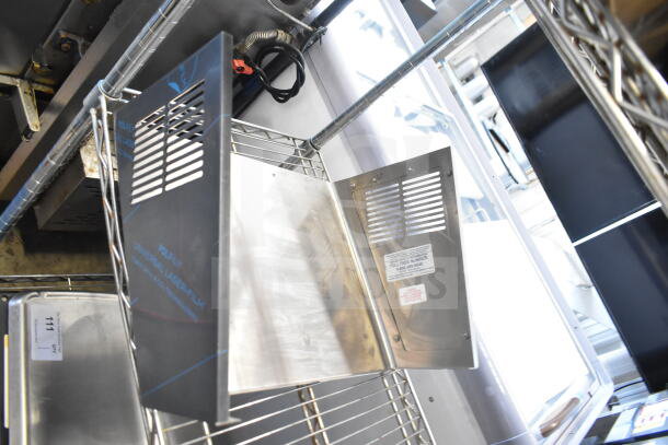 Metal panel with vents, Universal Laser Systems branding, and toll-free number label, auction lot of nine items.
