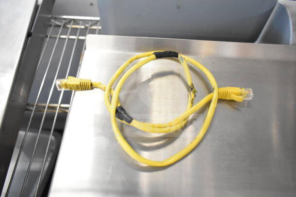 Mettler Toledo food portioning scale on countertop, includes wiring, tested and working, silver finish.
