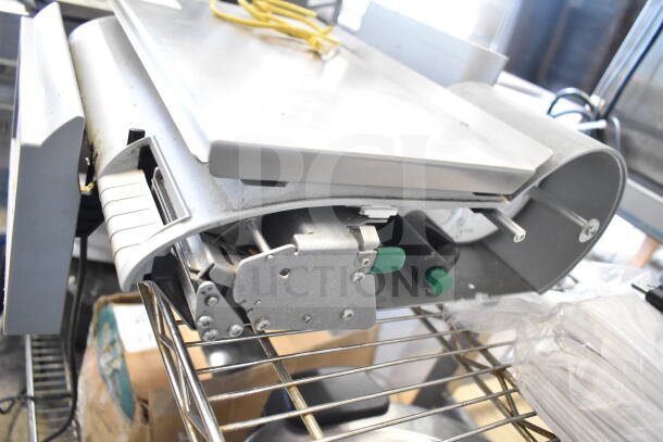 Mettler Toledo commercial countertop food portioning scale in working condition, showing metal components and controls.