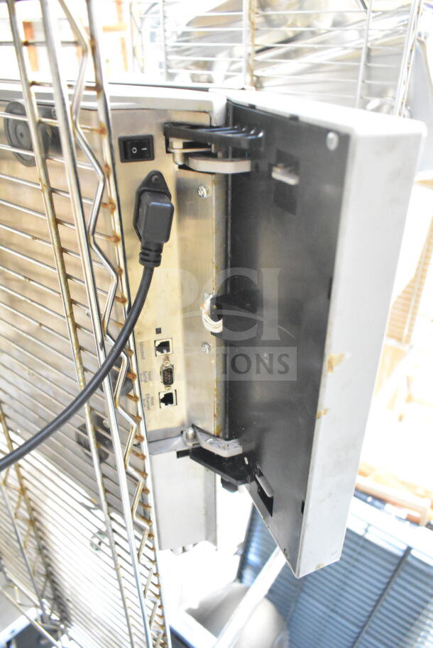Mettler Toledo commercial food portioning scale, tested and working, features connectivity ports and sturdy metal casing.
