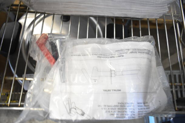 5 various items including sealed 42655.0007 faucet kit, drop-in bin, and 167704FSTW flour sack towels on metal shelf.
