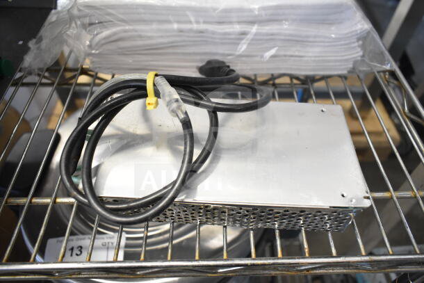 Assorted items including 42655.0007 faucet kit and 167704FSTW flour sack towels on a wire rack.