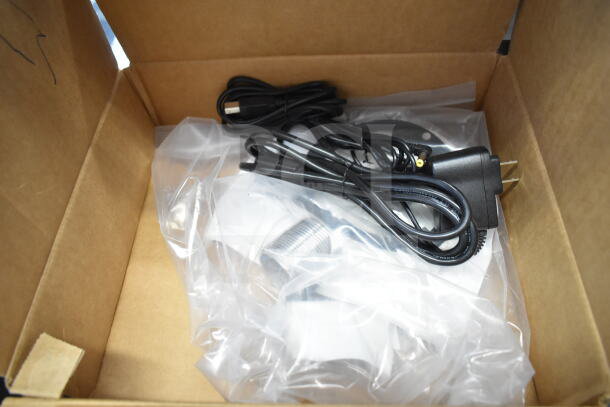 Box containing a Wren camera, SVW PTZ adapter, and cables, sealed in plastic packaging, showing new condition.