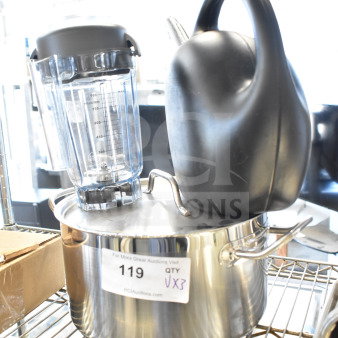 Watering can, blender pitcher, and stainless steel stock pot with label "119 QTY VX3" on a metal shelf.