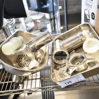 Stainless steel meat grinder attachments with trays and pushers, labels indicating quantity two, auction lot 120.