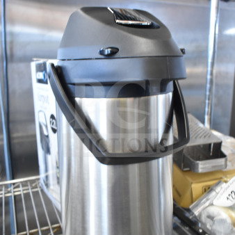 Brand new Avantco 3.5L stainless steel lined airpot with lever, in excellent condition, on a metal shelf.
