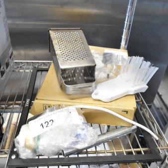 Eight mixed items including a metal cheese grater, white cleaning brush, and a Dell monitor frame. Auction lot includes varied household accessories.