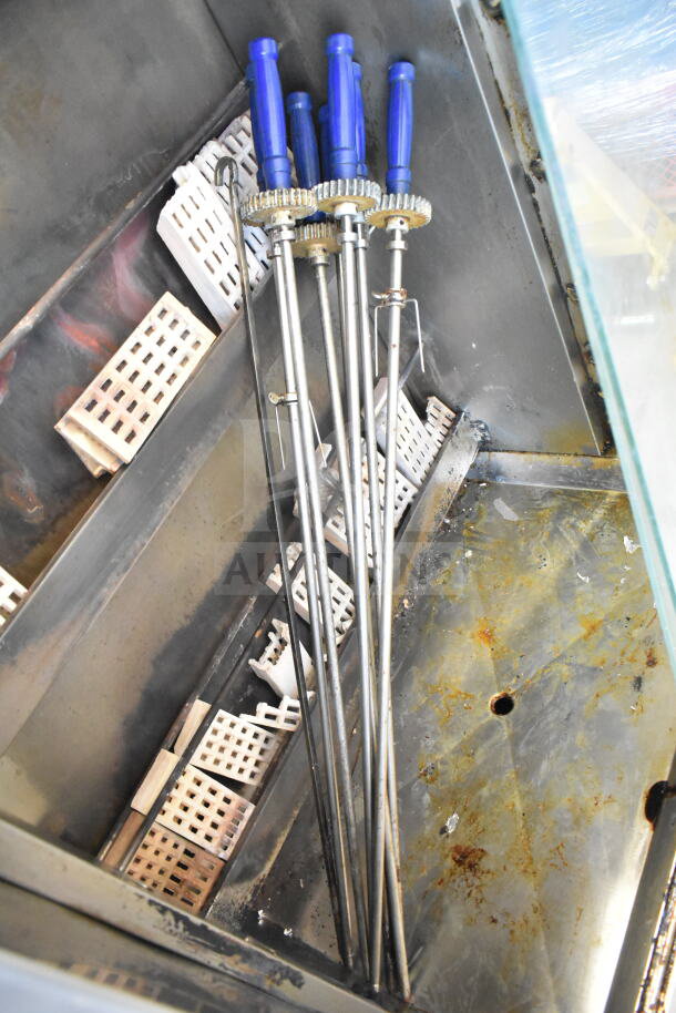 Attias commercial natural gas rotisserie oven with skewers, 70,000 BTU, on commercial casters, clean and functional condition.