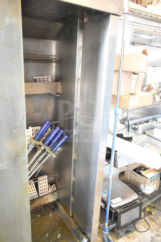 Attias commercial natural gas rotisserie oven on casters, 70,000 BTU. Features blue handles and visible signs of use.