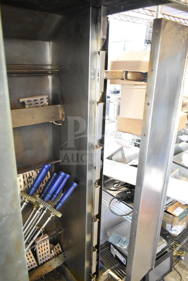 Attias Commercial Natural Gas Rotisserie Oven, 70,000 BTU, on casters. Features blue-handled spits. Used condition.