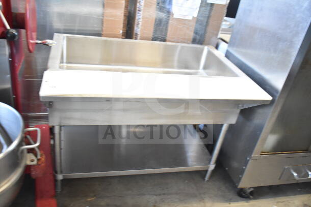 Commercial stainless steel steam table with under shelf, featuring a single basin and sturdy legs, in good condition.