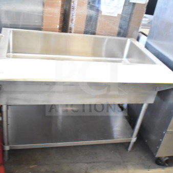 Commercial stainless steel steam table with under shelf, featuring a single basin and sturdy legs, in good condition.