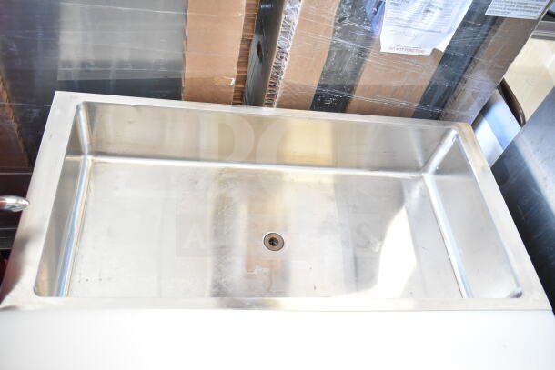 Commercial steam table with under shelf, stainless steel, features spacious basin, visible drain, good condition.