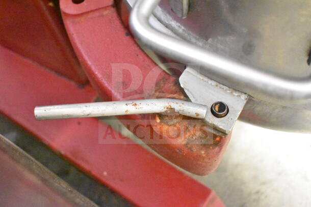 Attias USA 60 commercial dough mixer lever detail, showing worn metal and rust on red frame, indicating usage.
