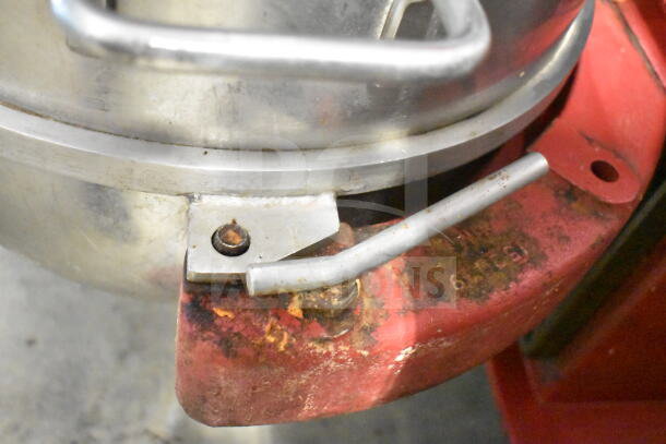 Attias USA 60 commercial mixer detail showing a metal handle and part of the red base. Visible wear and rust.