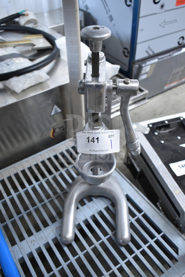 Nemco 55850 Countertop Manual Juicer, metal construction, visible auction tag indicating item number 141, used condition.