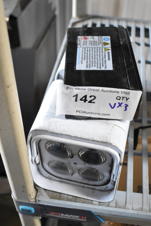Leoch battery and two Rockville lights on shelf, slight wear, auction lot label reading "142 QTY VX3".