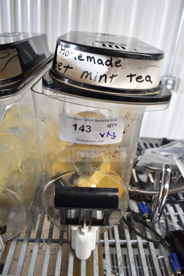 Two slushie machine hoppers and drip tray in used condition, labeled "Homemade Sweet Mint Tea," auction lot 143.