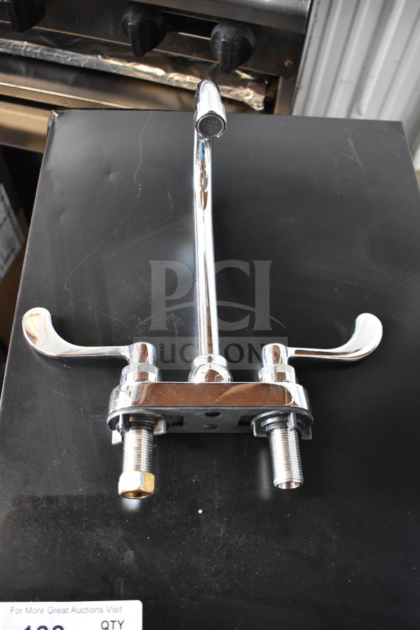 Chrome faucet with dual handles and T&S 013E-36H water hose, new condition, ready for installation.
