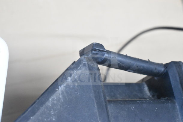 Close-up image of a speaker's mounting hardware, showing black plastic components, part of auction set with JBL and EV speakers.