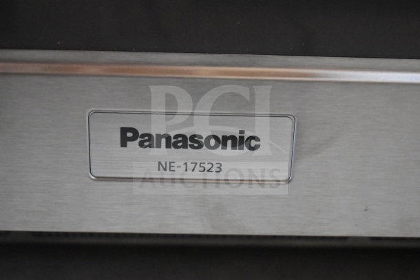 Panasonic NE-17523 countertop commercial microwave oven label, stainless steel finish, model identifier visible.