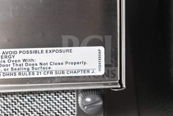 Panasonic NE-17523 commercial microwave oven, stainless steel, safety label visible. Model: NE-17523.