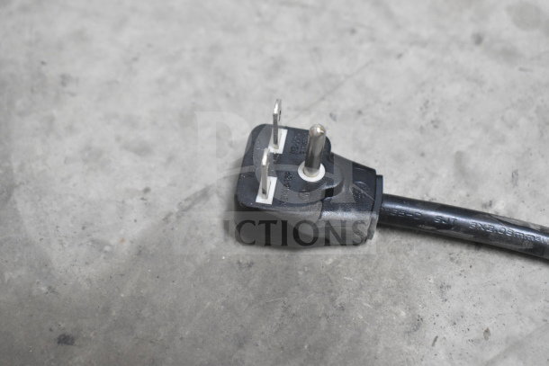 Close-up of a power plug for the Panasonic NE-17523 commercial microwave oven, showing prongs and cord in good condition.