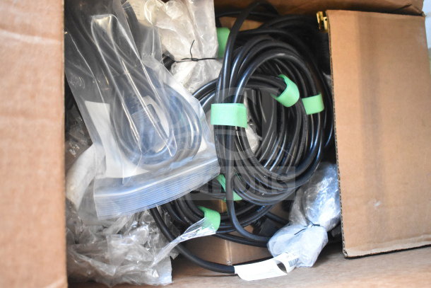 A box of wires, including coiled black cables with green ties, some in plastic bags. Condition appears unused.