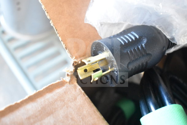 Box of wires with various electrical cords and connectors visible; features a black power plug with brass prongs in good condition.