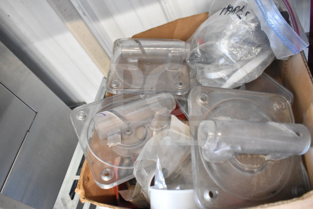 Box containing various Flavor Burst machine parts, including clear plastic components, in used condition.