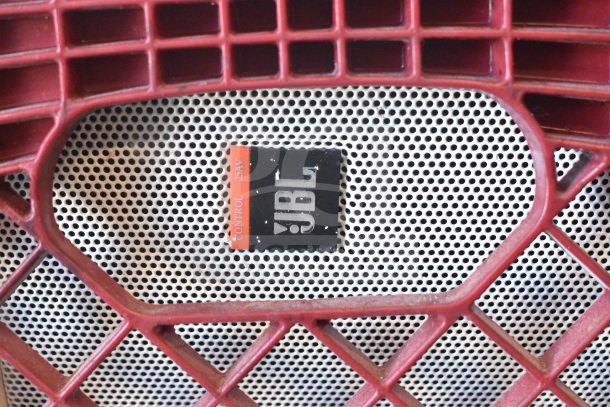 4 JBL Control 25AV speakers, shown with a red grille. Visible JBL branding label on silver perforated surface.