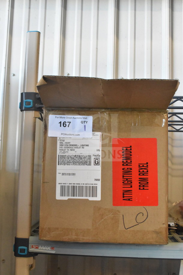 Box containing Dual Lite EVHCEZP emergency light back box and Dual Lite double remote head. Labels indicate shipping details.