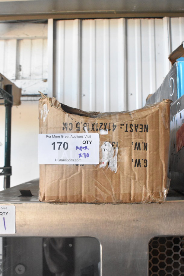 Cardboard box containing 70 sharpened stainless steel chef knives. Box shows wear. Auction lot label visible with "170 QTY x10".