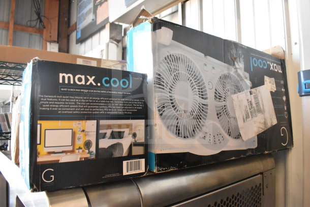Boxes of Max Cool fans showing packaging details and features, including dual fan design and safety protection. Slight wear visible.