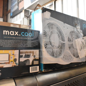 Boxes of Max Cool fans showing packaging details and features, including dual fan design and safety protection. Slight wear visible.