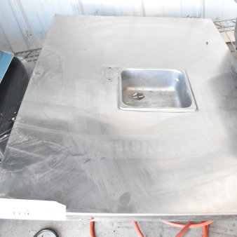 Steel panel with a recessed square compartment, slightly worn surface. Suitable for industrial use or repair projects.