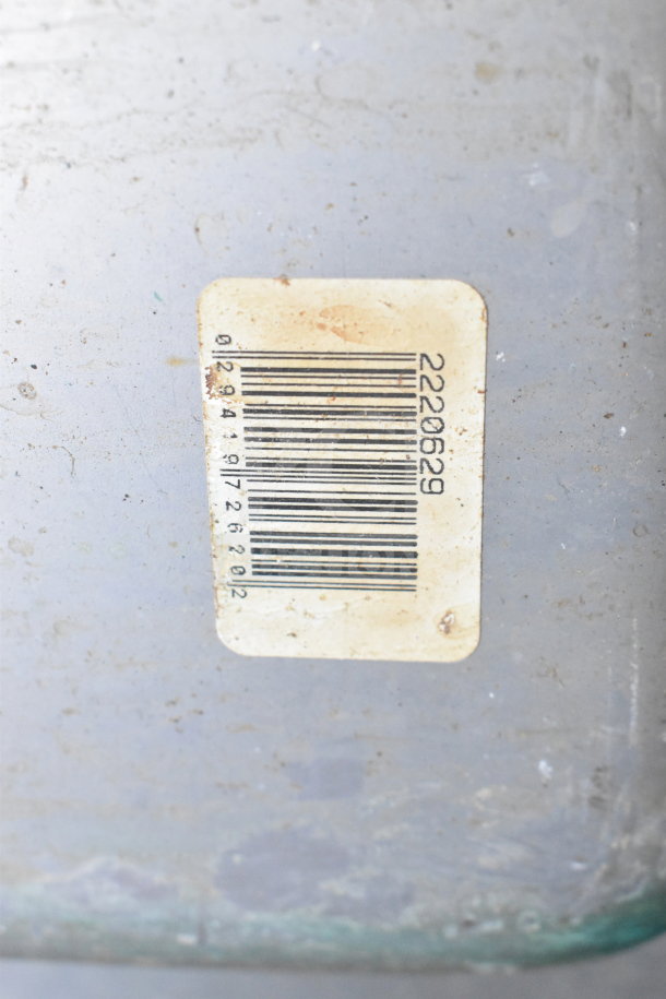 Metal panel with visible wear, featuring a barcode label numbered 2220629, slightly faded, minor surface rust.