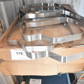 Stainless steel folding chafer frames on a cardboard box. Includes 5 baking pans. Condition: used. Auction label visible.
