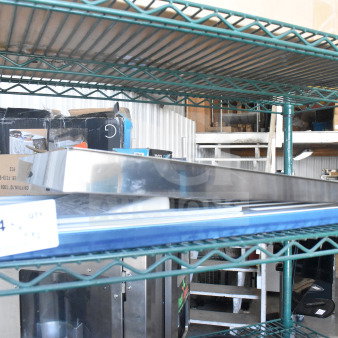 Two-item auction lot including a metal bin on a shelf, label showing "184" quantity. Various boxes visible.
