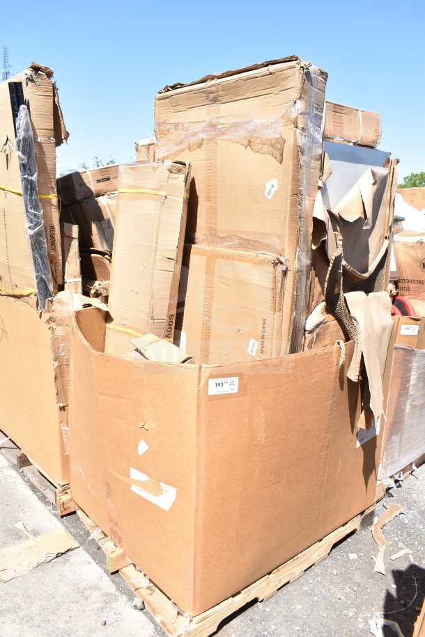 Pallet of nine brand new scratch and dent items, including a table and utility cart, in damaged cardboard boxes.