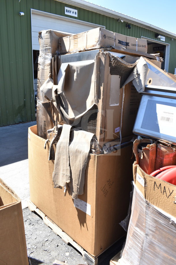 9 new scratch and dent items including a table and utility cart in large cardboard boxes, visible labels and packaging wear.