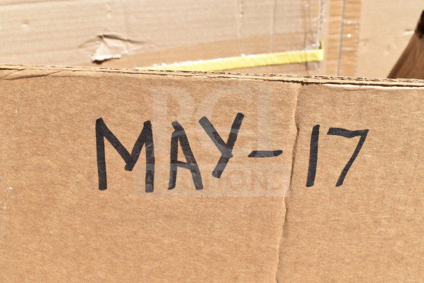 Cardboard box labeled "MAY-17" containing 9 new scratch and dent items, including a table and utility cart.