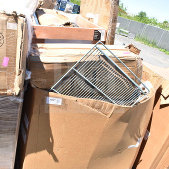 Large cardboard boxes showing 12 brand new scratch-and-dent items, including tabletop and table base columns, stacked outdoors.
