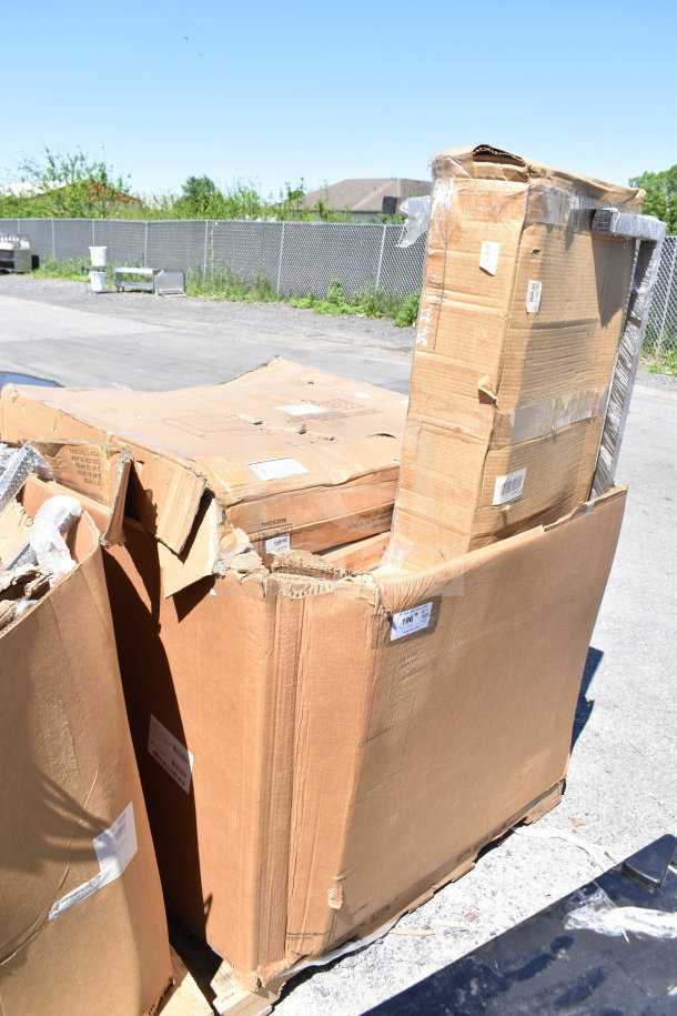 Damaged cardboard boxes on a pallet containing new scratch and dent items, including a dunnage rack. Tags visible.