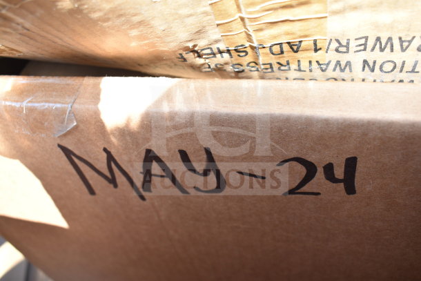 Brown cardboard box labeled "MAY-24," part of auction lot with five brand new scratch and dent items, including a dunnage rack.