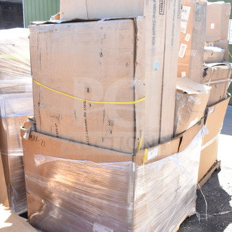 Stack of eight new scratch and dent items in cardboard boxes including a work table, wrapped on a pallet. Box labeled "MAY-21."