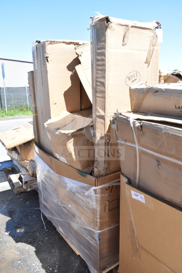 Pallet of brand new scratch and dent items, including work table, in damaged boxes with wear. Labels indicate item codes.