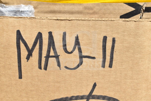 Cardboard with handwritten "MAY-11," indicating auction date. Contains 15 new scratch and dent items, including forks and fryer basket.