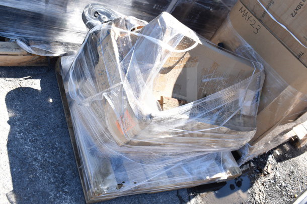 Four brand new scratch and dent items, including a trash cart, wrapped on a pallet. Boxes labeled "MAY23."