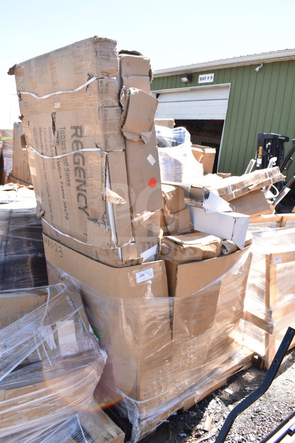 Stack of new items with scratch and dent, including table base columns and legs, wrapped in boxes. Regency branding visible.